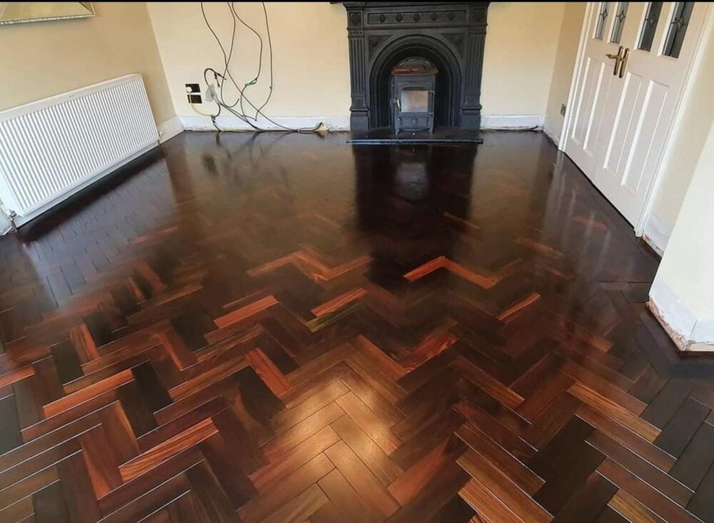 Elegant solid rosewood herringbone flooring with rich natural hues and intricate patterns, installed by expert floor fitters for a luxurious, durable finish