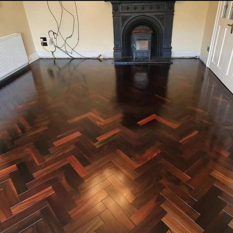 Elegant solid rosewood herringbone flooring with rich natural hues and intricate patterns, installed by expert floor fitters for a luxurious, durable finish