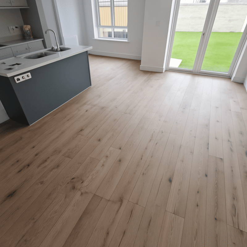 Medium oak bespoke engineered plank flooring in a bright modern kitchen with natural grain and warm brown tones.